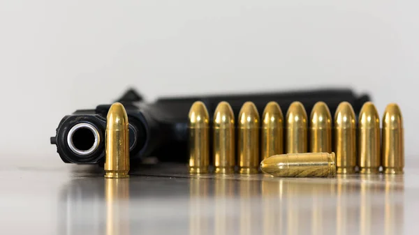 close-up photos of handguns and pistol bullets