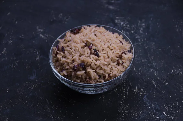 Rice and beans in a bowl. Pot full of  moros and cristianos also known as congris rice or gallo pinto