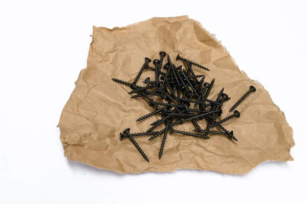 Black Tapping Screws Kraft Paper White Background — Stock Photo, Image