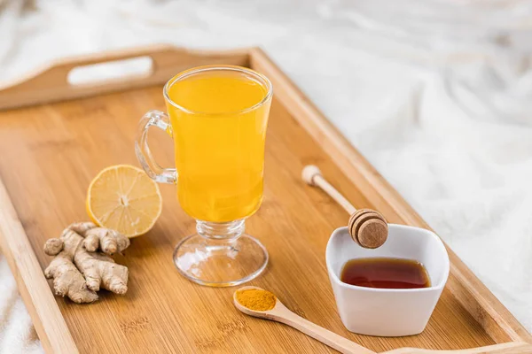 Ingredients for turmeric hot tea. Healthy ayurvedic drink with lemon, ginger, cinnamon, turmeric. Immune boosting remedy.
