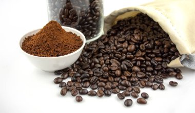 Cup of coffee, bag and scoop on white background.