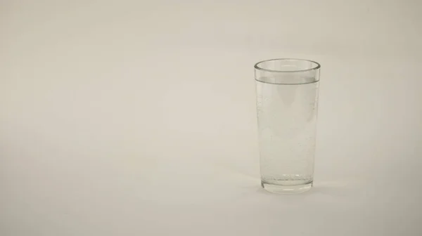 glass of crystal clear water on a white background