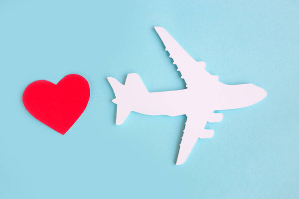 toy airplane on blue table with red heart