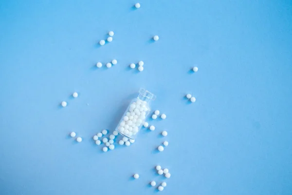 Homeopathische bolletjes en glazen fles op roze achtergrond. Alternatieve Homeopathie — Stockfoto