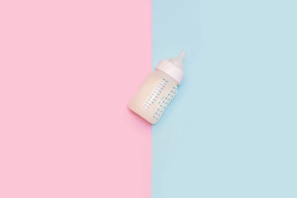 Bottle of milk for a newborn on a pink background. — 스톡 사진