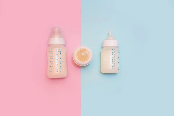 Bottle of milk for a newborn on a pink background. — 스톡 사진