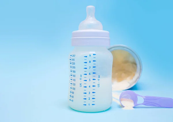 Bottle of milk for a newborn on a pink background.