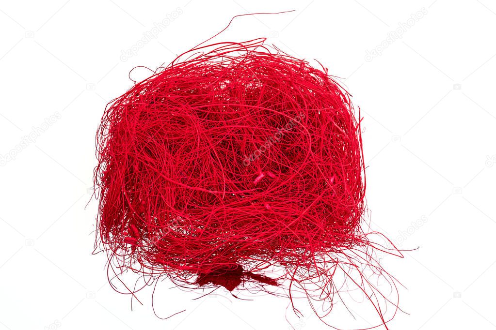 a ball of red colored flax hair ribbon isolated on white backgro