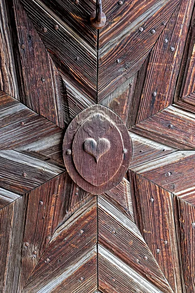 Wooden door with carved stars and a heart — 스톡 사진