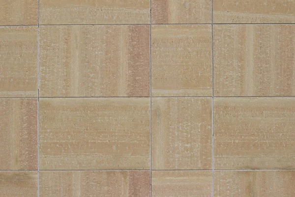 Modern beige and brown color stone block wall texture background with natural stone containing varying color striations