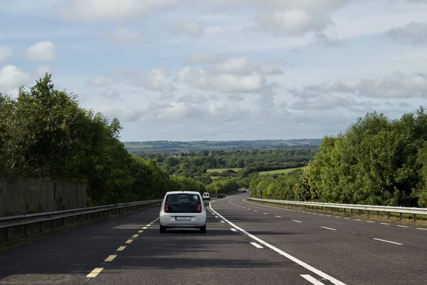 Landscape view of an automobile traveling on a modern highway in western Ireland