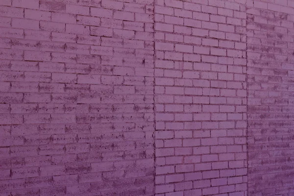 古い修復ピンク塗装レンガの壁のテクスチャの背景に2つの異なるレンガ造りのパターン 角度ビュー — ストック写真