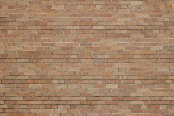 Rosy pink color brick wall texture background with a touch of weathered grunge, in a common bond brickwork pattern