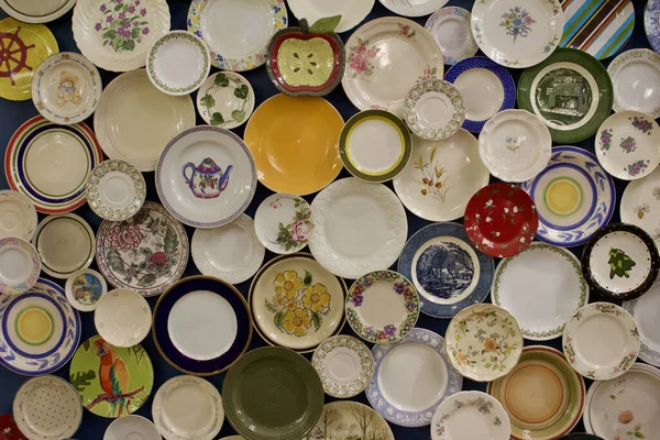 Colorful collection of vintage dinner plates arranged in an artistic collage
