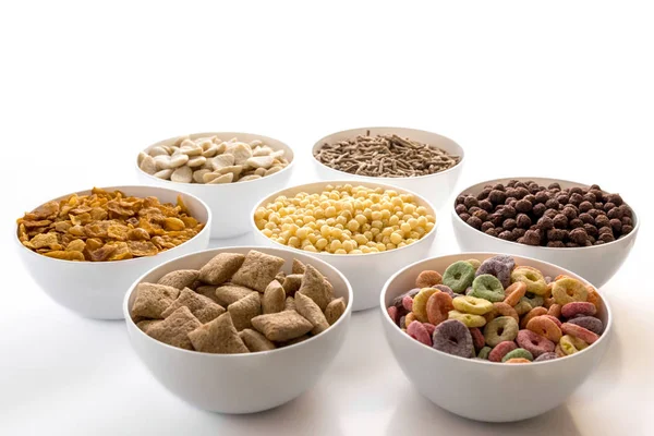 Image with white bowls and colored cereals — Stock Photo, Image