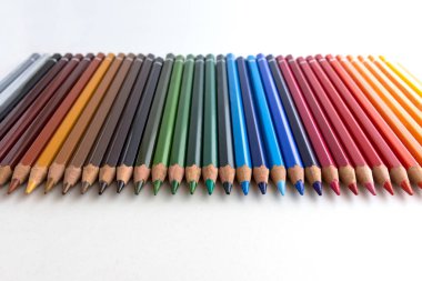 Beyaz arkaplanda renkli kalemler, hizalanmış