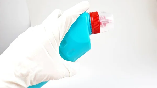 Синяя Пластиковая Бутылка Красной Крышкой Руке Резиновой Белой Перчатке Белом — стоковое фото