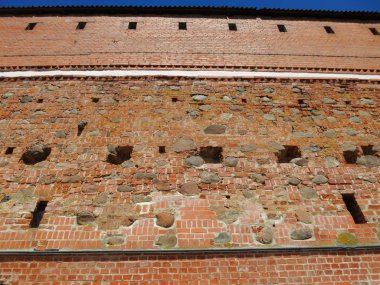 Background wall of the old castle of red stone and brick