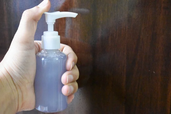 Hand pumping a hand wash from pump dispenser bottle
