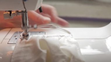 Dikiş makinesine tıbbi maske dikiyorum.