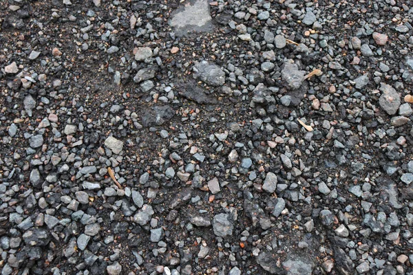 Background of blue stones on the ground.  Gravel road