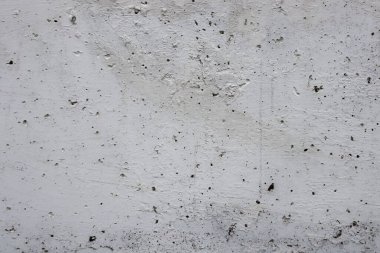 Bir tasarım ya da ürün için pürüzlü ve pürüzlü gri desenli beton arka plan. Delikleri olan pürüzlü gri yüzey