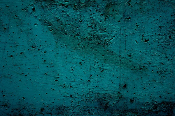 Grungy uneven turquoise background. Turquoise uneven surface with holes for design and text