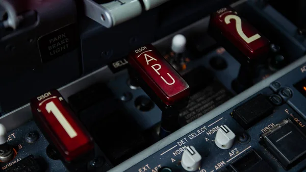 Modern ulaşım uçağı kokpitinin ayrıntıları jet motoru ve apu yangın korumalı yangın anahtarlarını seçici odaklı gösteriyor.