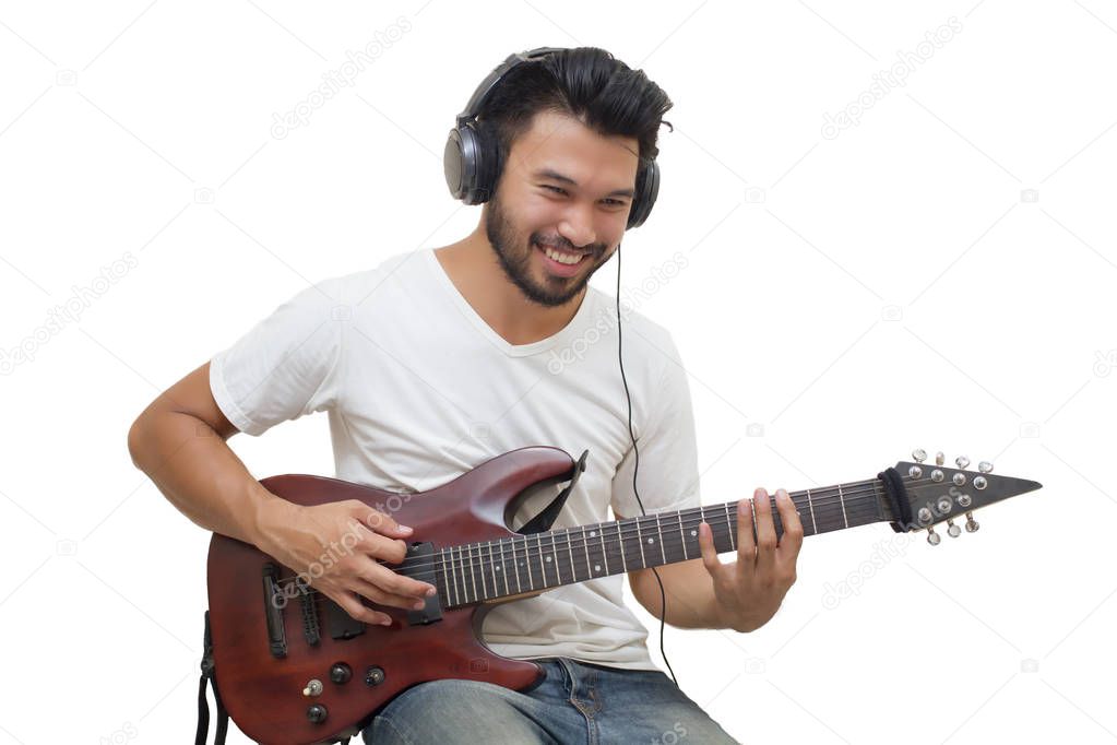 Handsome young asian men playing guitar and  listen music with h