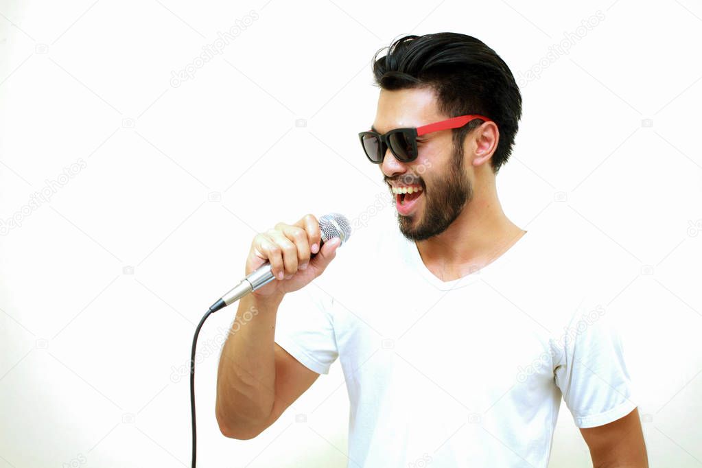 Asian handsome man with a mustache, smiling and singing to the m