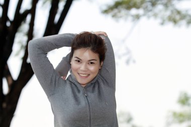 Atletik kadın Asya ısınma ve oturan genç kadın atlet 