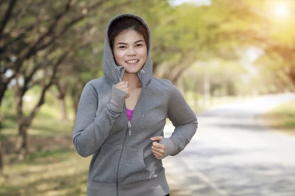Running woman. Female runner jogging during outdoor on road .You