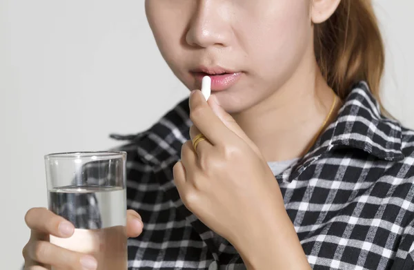 Asian women are taking medicines and vitamins for help Sick and