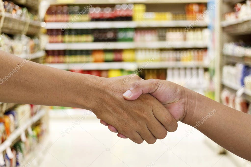 handshake in a business and deal in the  supermarket/mall for ba