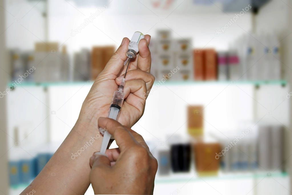  Hands the doctors filling a syringe on store medicine and pharm