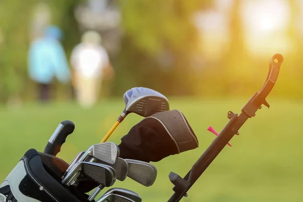 Golfový bag a profesionální golfové vybavení na golfovém hřišti při západu slunce — Stock fotografie
