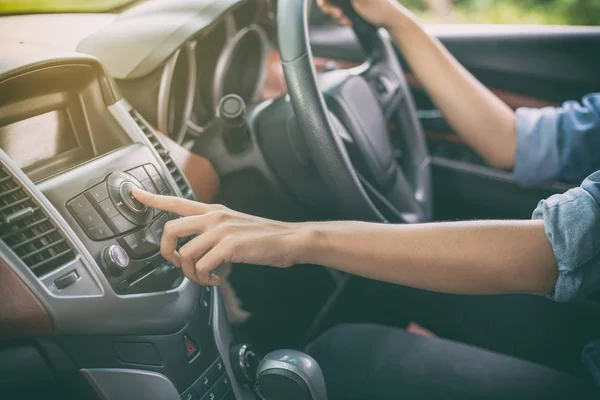 Mujeres asiáticas presionan botón en la radio del coche para escuchar música . — Foto de Stock