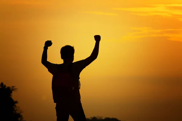 Silhouette of man travel show arm up for achievements successful — Stock Photo, Image