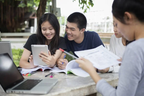 Asian Group of students using tablet and notebook sharing with t — Stock Photo, Image