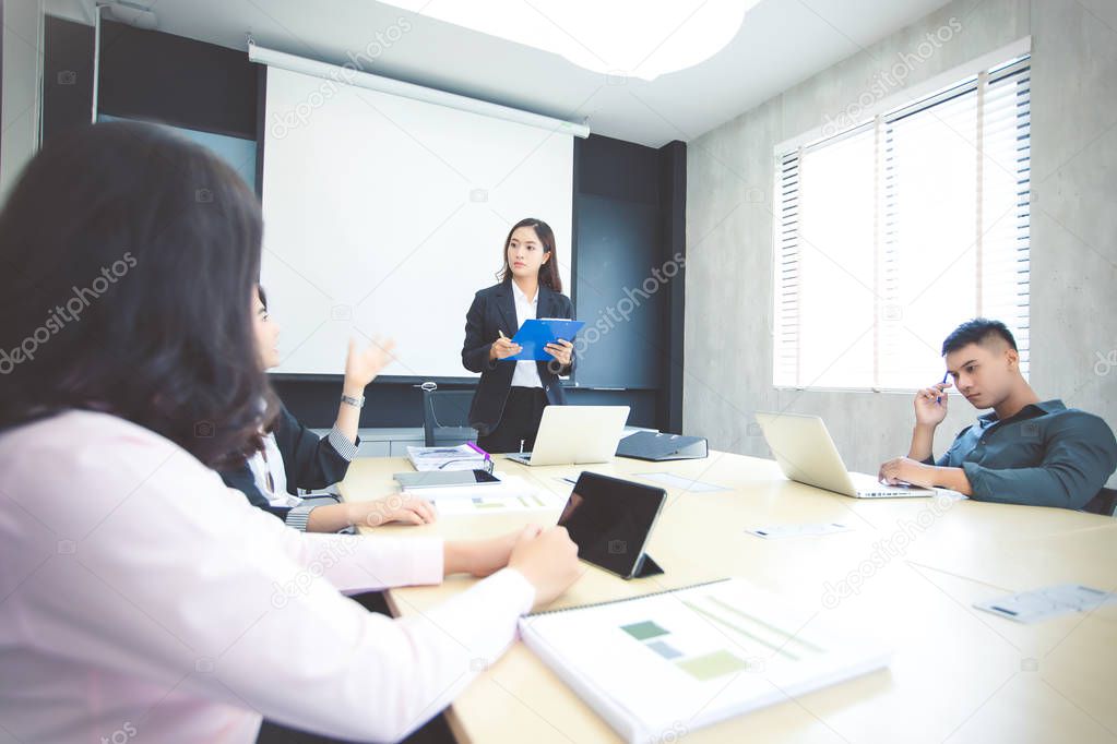 Asian businessmen and group using notebook for meeting serious a