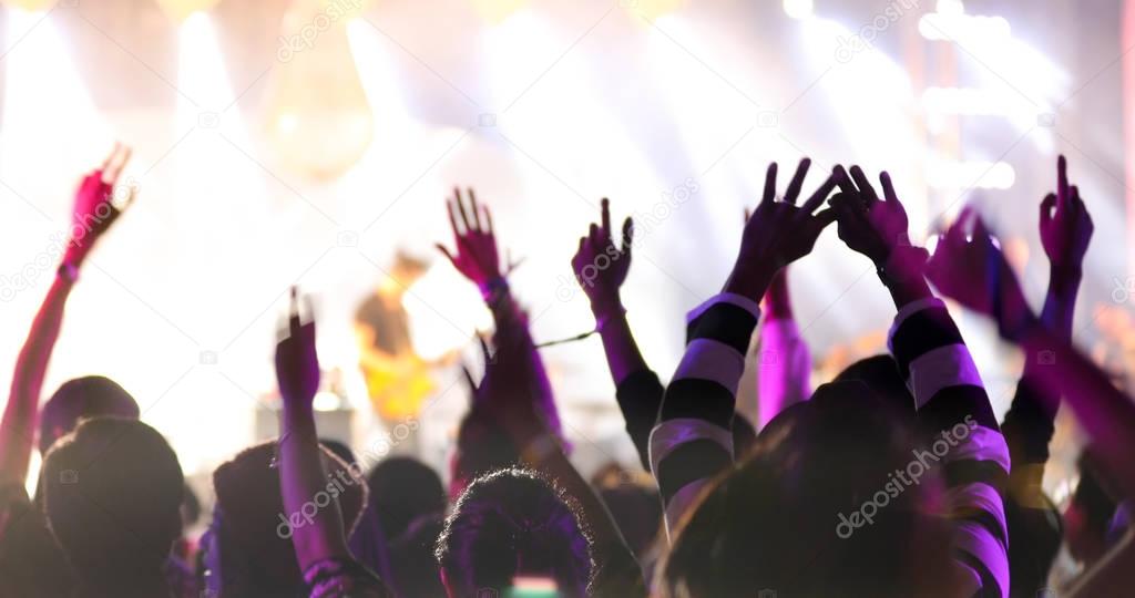 silhouettes of concert crowd at Rear view of festival crowd rais