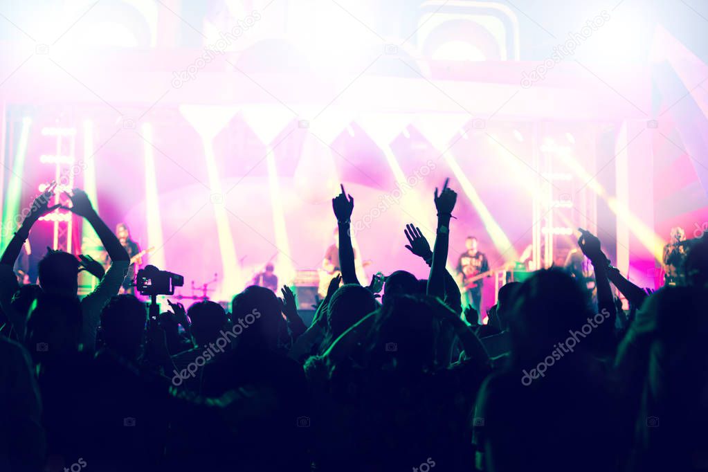 silhouettes of concert crowd at Rear view of festival crowd rais