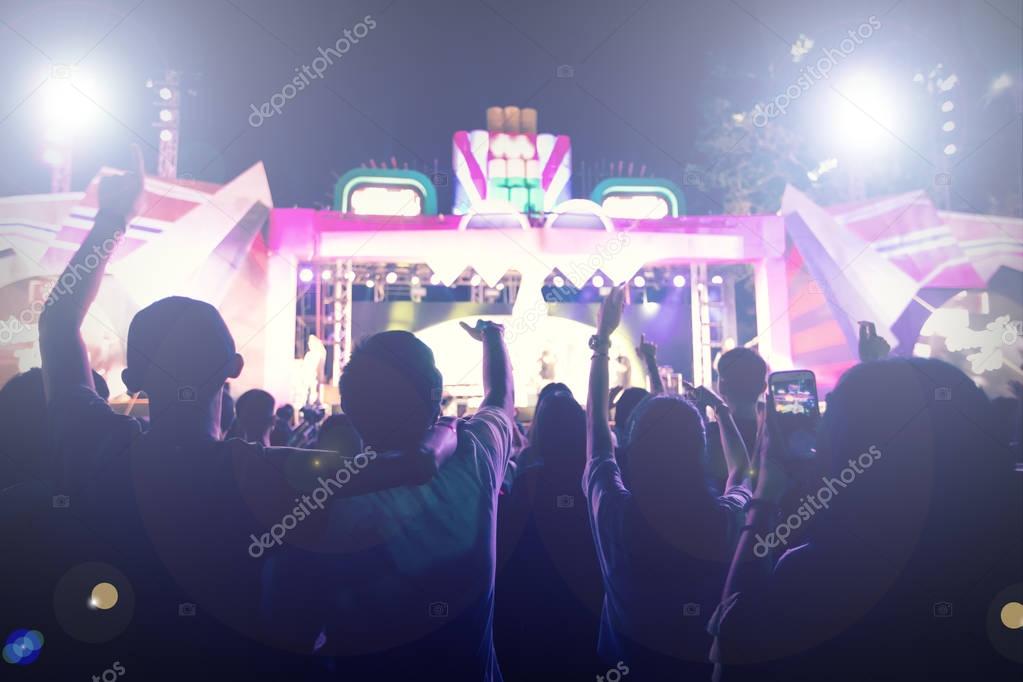 silhouettes of concert crowd at Rear view of festival crowd rais