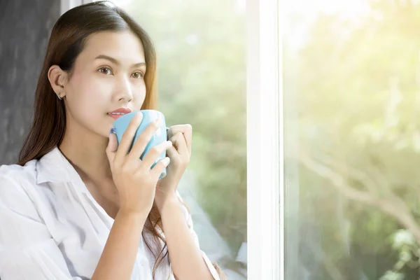Asian women drinking coffee and wake up in her bed fully rested