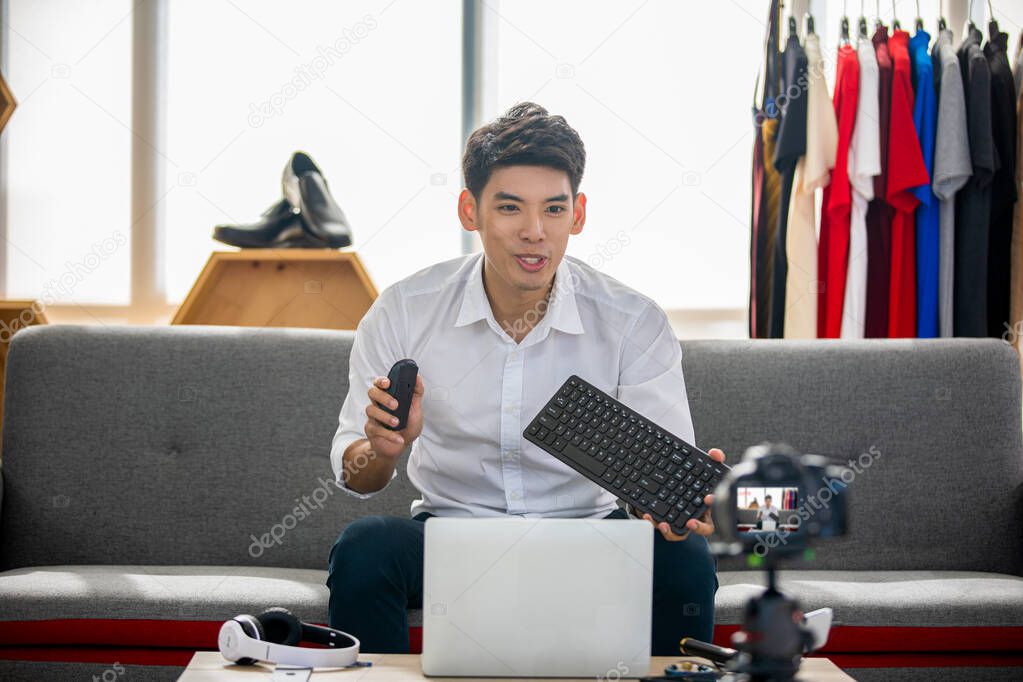 Asian man  blogger broadcasting a video for selling product onli