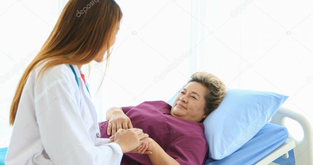 Doctor meeting and explaining medication to old woman patient at