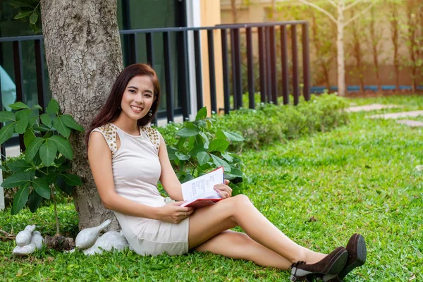 Азиатка читает книгу в саду для релаксации — стоковое фото