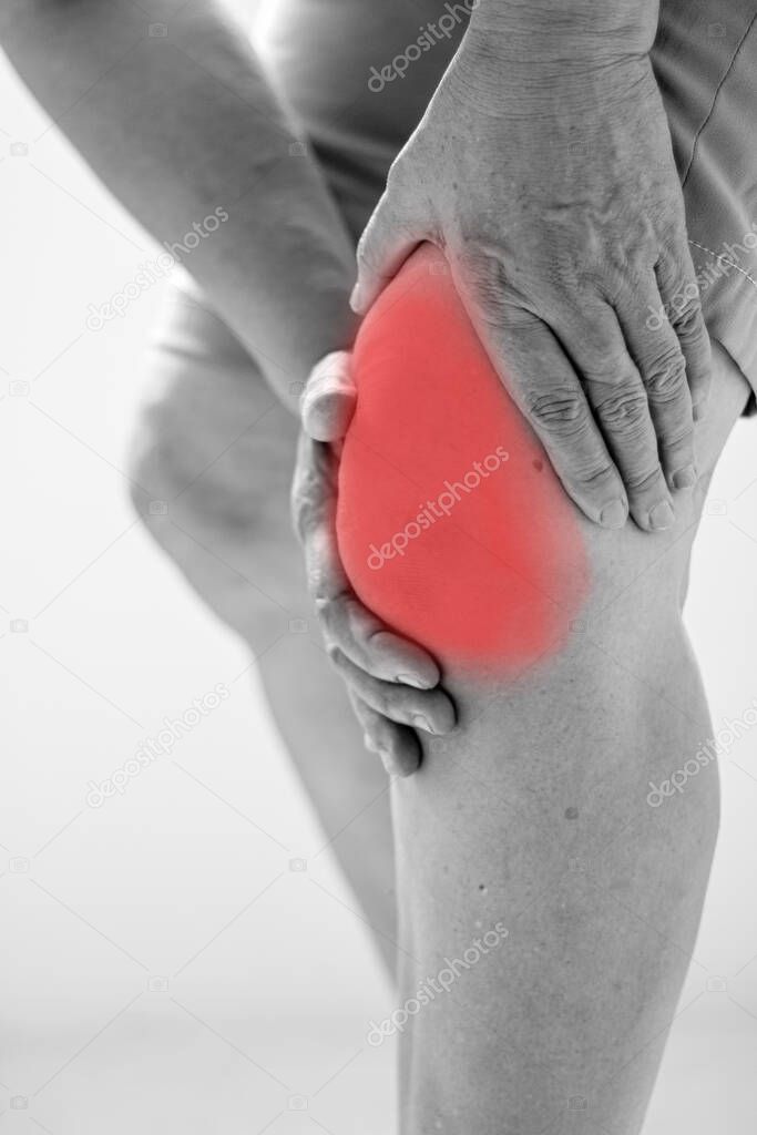 Old Asian women to knee injury on white background,black and whi