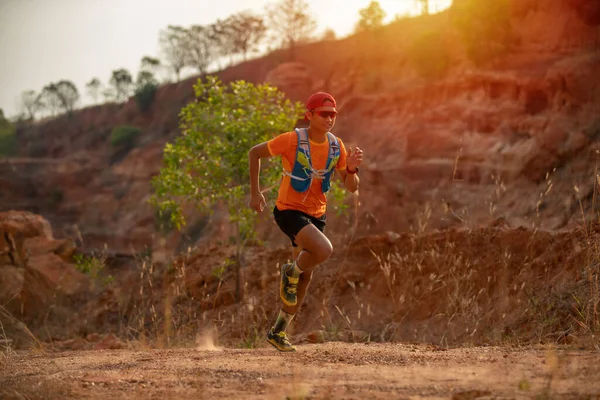 トレイルの男ランナーと選手の足は山の中を走るトレイルのためのスポーツシューズを着て — ストック写真