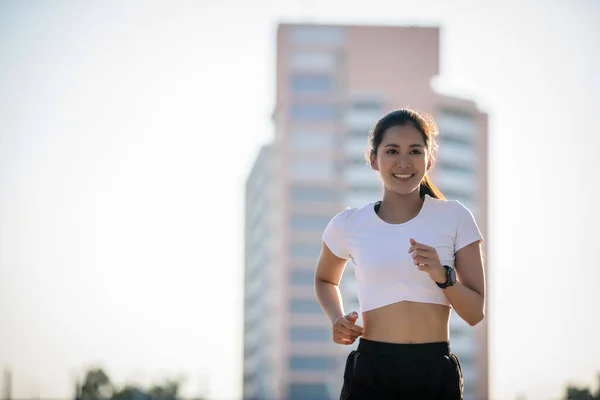 Ασιατική Νεαρή Αθλητική Γυμναστική Γυναίκα Τρέχει Και Χαμογελά Στο Δρόμο — Φωτογραφία Αρχείου